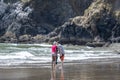 Mom dad and daughter take a selfie on the shore of the Northwest Pacific