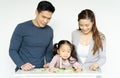 Mom, dad and girl playing together with wooden toys on white room..Daughter with unhappy with the parents after playing with her