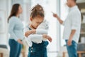 Are mom and dad going to get divorced. a young girl looking sad while her parents argue. Royalty Free Stock Photo