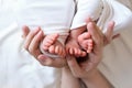 Mom and dad hands hold small legs of their two newborn twin babies Royalty Free Stock Photo