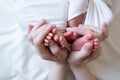 Mom and dad hands hold small legs of their two newborn twin babies Royalty Free Stock Photo