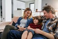 Mom, dad and happy family relax on sofa in living room with love, quality time and chat together at home. Young boy Royalty Free Stock Photo