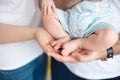 Mom and Dad hold baby legs. Taking care of a newborn. Royalty Free Stock Photo