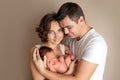 Mom and dad hold a newborn baby, replenishment in the family, discharge from the hospital, happy family, mother`s day