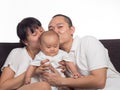 Mom and dad kiss baby Royalty Free Stock Photo