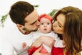 Mom and dad kissing their cute newborn baby daughter Royalty Free Stock Photo