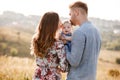 Mom, dad kissing their little girl on summer day. mother`s, father`s and baby`s day. Happy family for a walk outside the town Royalty Free Stock Photo