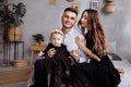 Mom, dad and little girl having fun and hugging at home on bed. mother`s, father`s and baby`s day. Happy family holiday indoors Royalty Free Stock Photo