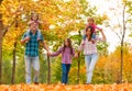 Mom dad and little girls walk in forest together