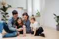 Family building tower from blocks, taking turns, picking and placing on top Royalty Free Stock Photo