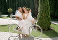 Mom and dad ride their daughter in a basket on a bicycle. Family vacation. The child is happy and laughs loudly .