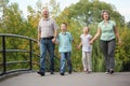 Mom, dad, son and daughter is walking on bridge Royalty Free Stock Photo