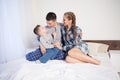 Mom dad and son in the morning in the bedroom on the bed Royalty Free Stock Photo