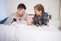 Mom dad and son in the morning in the bedroom on the bed Royalty Free Stock Photo