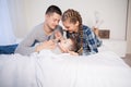 Mom dad and son in the morning lying on the bed at home in a good mood Royalty Free Stock Photo