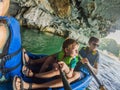 Mom, dad and son travelers rowing on a kayak in Halong Bay. Vietnam. Travel to Asia, happiness emotion, summer holiday