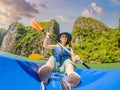 Mom, dad and son travelers rowing on a kayak in Halong Bay. Vietnam. Travel to Asia, happiness emotion, summer holiday