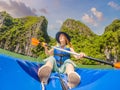 Mom, dad and son travelers rowing on a kayak in Halong Bay. Vietnam. Travel to Asia, happiness emotion, summer holiday