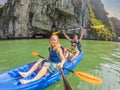 Mom, dad and son travelers rowing on a kayak in Halong Bay. Vietnam. Travel to Asia, happiness emotion, summer holiday Royalty Free Stock Photo