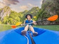 Mom, dad and son travelers rowing on a kayak in Halong Bay. Vietnam. Travel to Asia, happiness emotion, summer holiday