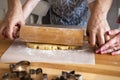 Mom and Dad teach a young child how to make cookies in the kitchen. family baking