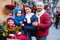 Mom and dad with their kids buying souvenirs