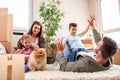 Mom, dad, their kids and their dog moving in the new apartment and having fun Royalty Free Stock Photo