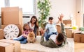 Mom, dad, their kids and their dog moving in the new apartment and having fun Royalty Free Stock Photo