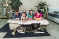 Mom, dad and two daughters relax at home and play with the dog on weekends. The concept of a ideal family who spends