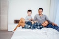 Mom dad and son in the morning lying on the bed at home in a good mood Royalty Free Stock Photo