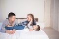 Mom dad and young son in the morning in bed after sleeping Royalty Free Stock Photo