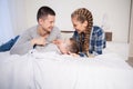 Mom dad and young son in the morning in bed after sleeping Royalty Free Stock Photo