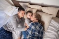 Mom dad and young son in the morning in bed after sleeping Royalty Free Stock Photo