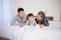 Mom dad and young son sleep on the bed in the bedroom Royalty Free Stock Photo