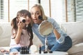 Mom and Daughter applying cosmetic with brushes Royalty Free Stock Photo