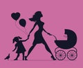 Mom with daughter and baby in baby carriage. Little girl feeds b Royalty Free Stock Photo