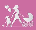 Mom with daughter and baby in carriage. Little girl feeds b Royalty Free Stock Photo