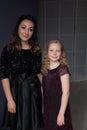 Beautiful mom and daughter in black dresses in close family