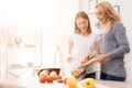 Mom and daughter are cooking together in the kitchen. Royalty Free Stock Photo