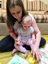 Mom and daughter do handprints with yellow paint Royalty Free Stock Photo