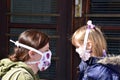 Mom and daughter with facemasks against coronavirus.