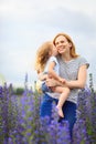 Mom and daughter in field with purple flowers