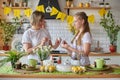 Mom and daughter in the kitchen prepare for Easter and paint eggs Royalty Free Stock Photo