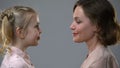 Mom and daughter leaning heads, trusting relations with parents, reliance