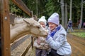 Mom and daughter caress the face of a foal at the petting zoo. Royalty Free Stock Photo