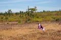 Mom with daughter piking cranberry