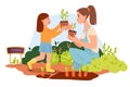 Mom and daughter are planting flowers in the garden. Organic gardening.