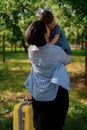 Mom and daughter are preparing for the trip. A little girl sits on a yellow suitcase suitcase. Go on a trip, relax at sea, collect Royalty Free Stock Photo