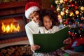 Mom and daughter reading Christmas fairytales Royalty Free Stock Photo