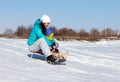 Mom and daughter rideing on sledge